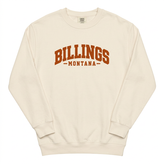 Cream Billings Montana crewneck sweatshirt with burnt-orange lettering on a white background
